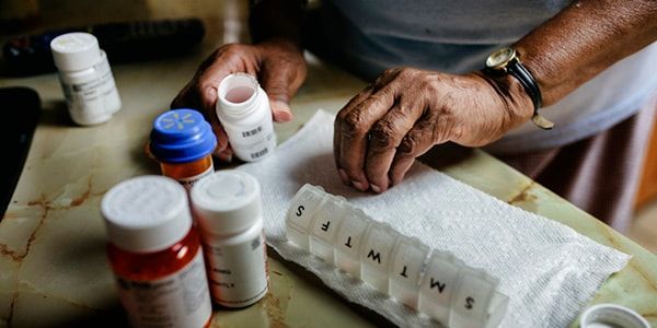 man organizing medication