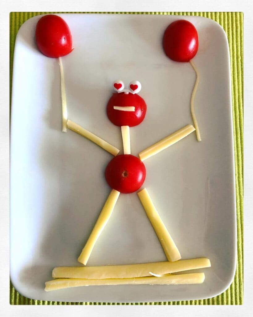 string cheese and cherry tomato snack person