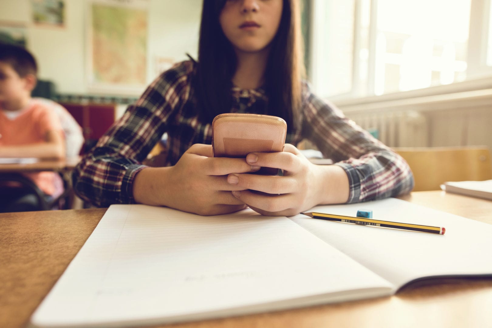 Parents are texting their kids in class so much that schools are banning phones