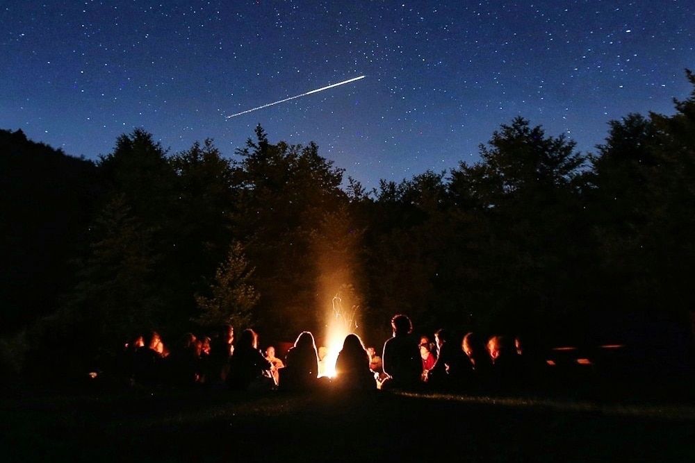 telling scary stories at the campfire (from