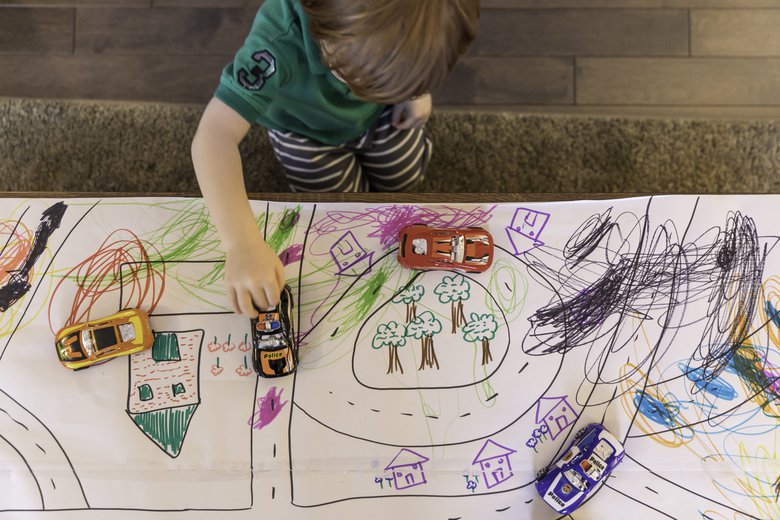 Draw roads on butcher paper and add toy cars for a fun after-school activity for kids
