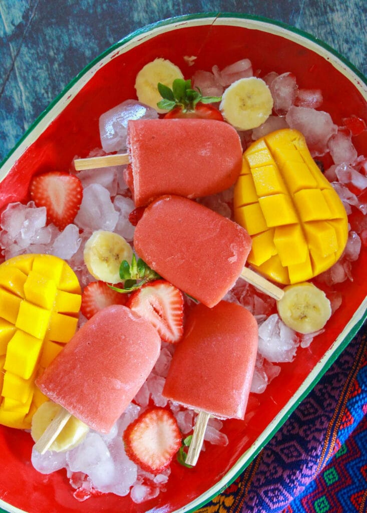 Making Strawberry Mango Banana Paletas is a fun way to celebrate National Hispanic Heritage Month with kids