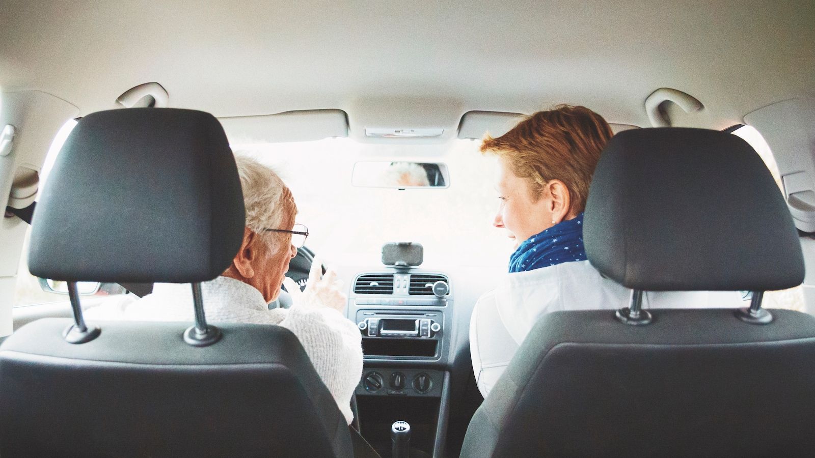Senior father and daughter chatting while driving