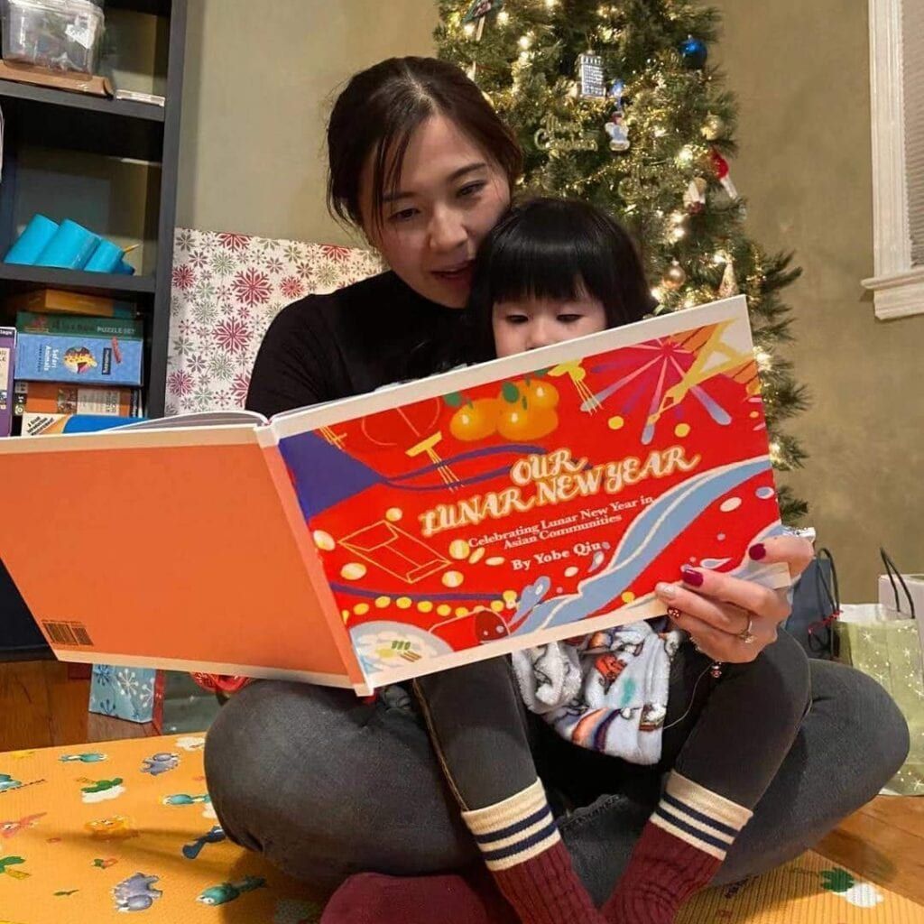 Mom reading book Our Lunar New Year to child