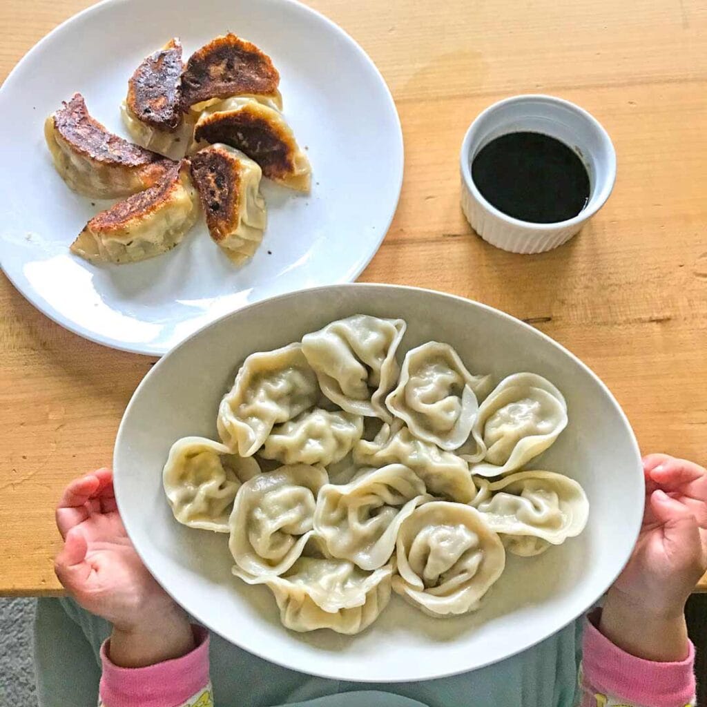 Asian American kids making dumplings and pot stickers for Lunar New Year