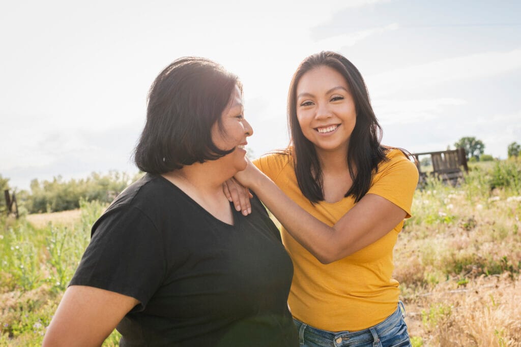 Native American mother and daughter laughing 