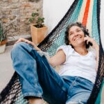 Happy nanny on her day off lying in hammock relaxing